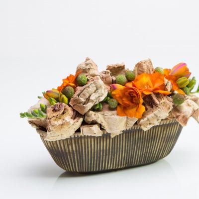 Warm flower arrangement with Freesia and cork