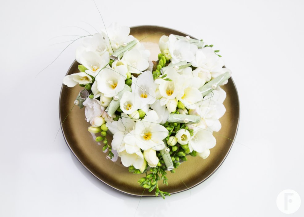 White Freesia on golden platter